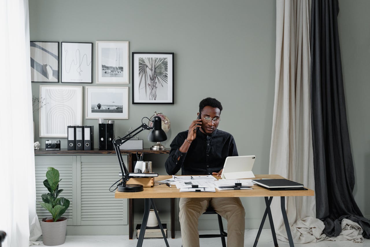 Crafting Captivating Headlines: Your awesome post title goes here Businessman talking on phone while working in stylish office with tablet and documents.